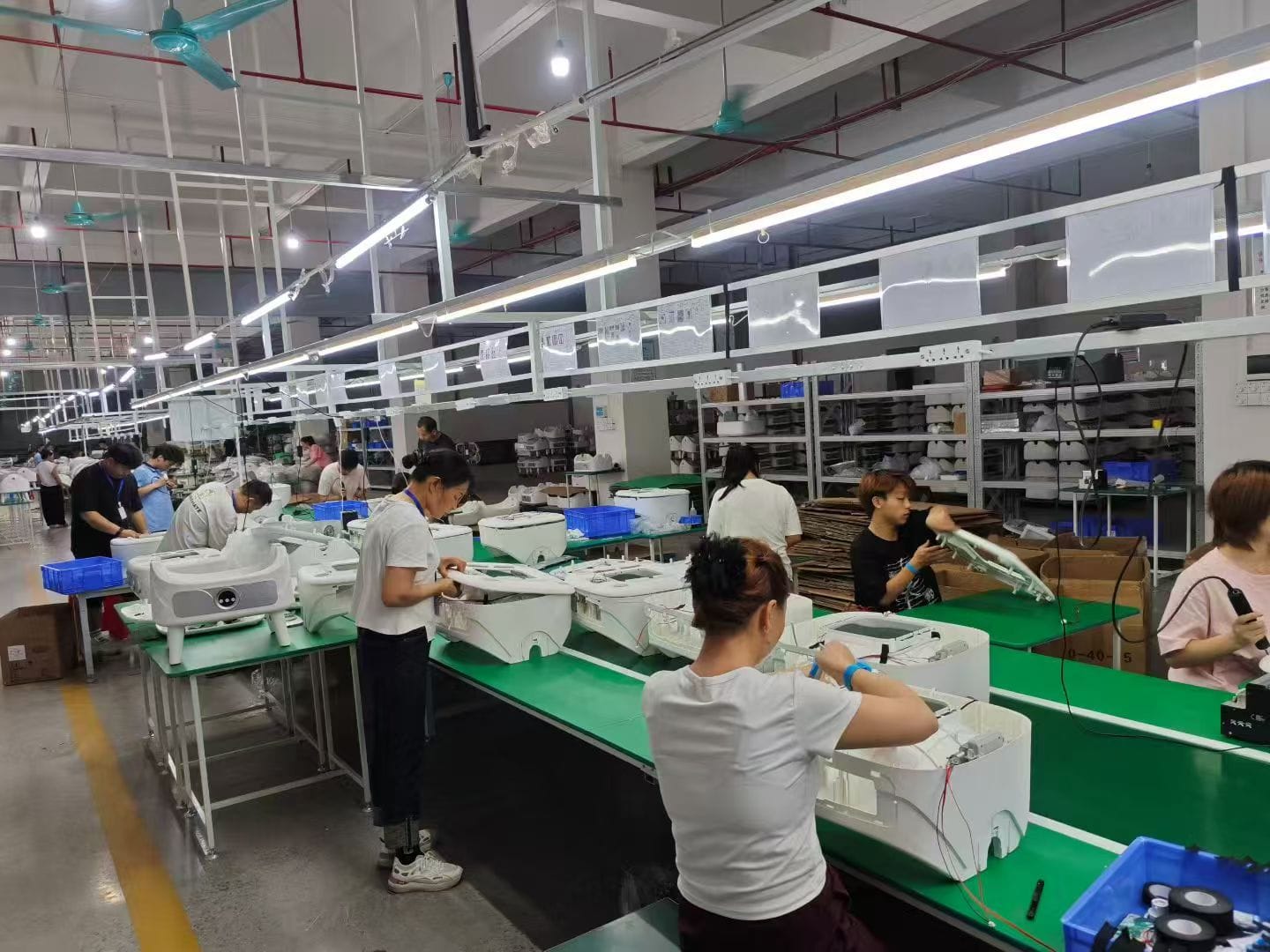 Smart litter box assembly line with operators in the production workshop