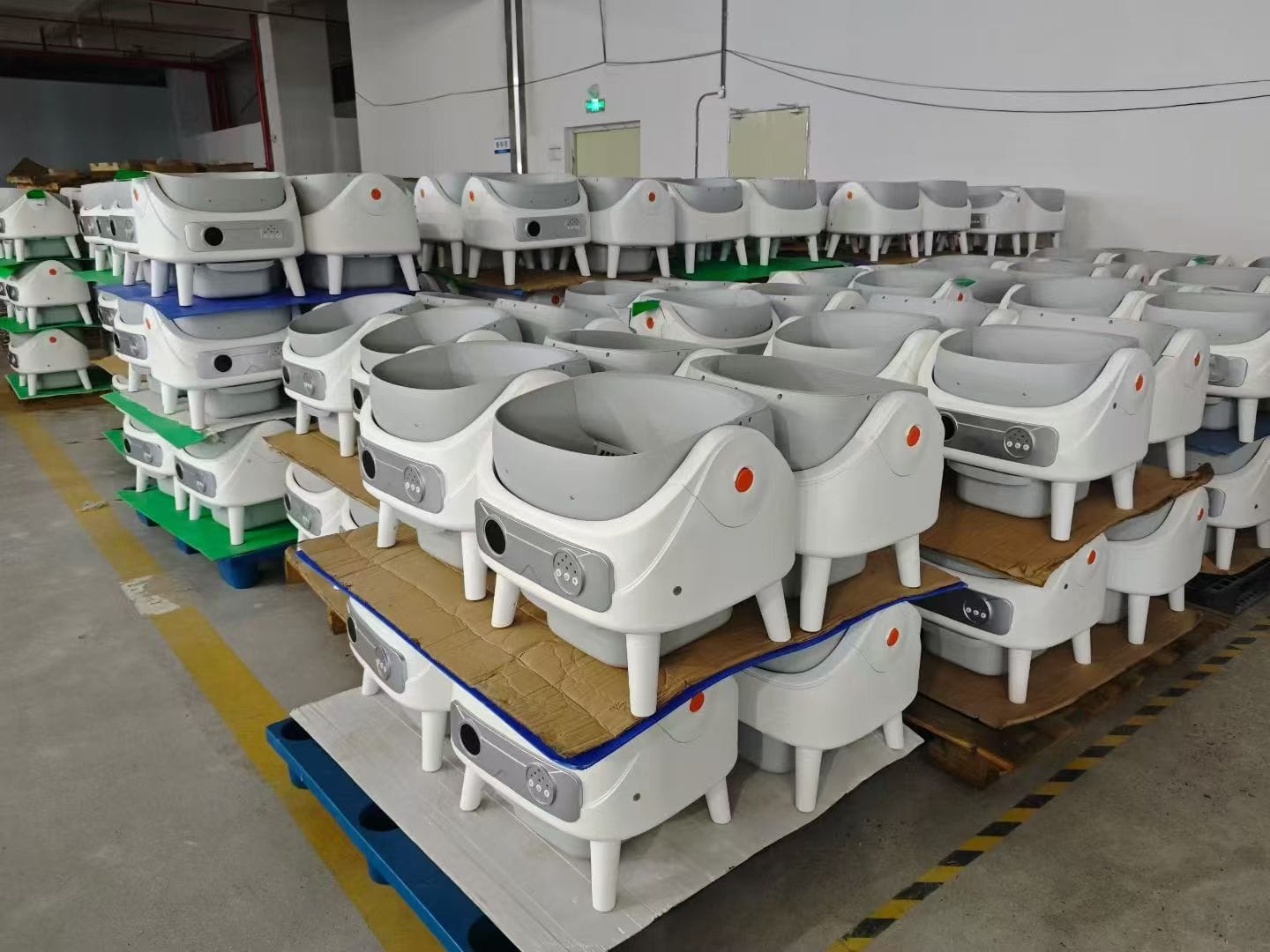 Finished smart litter boxes staged in batches for packing and shipment